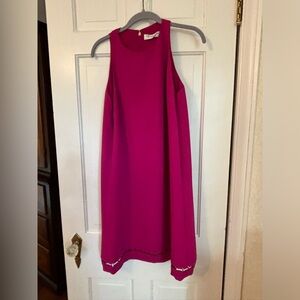 Trina Turk size 12.A/line, knee length, with brass detail at the bottom.